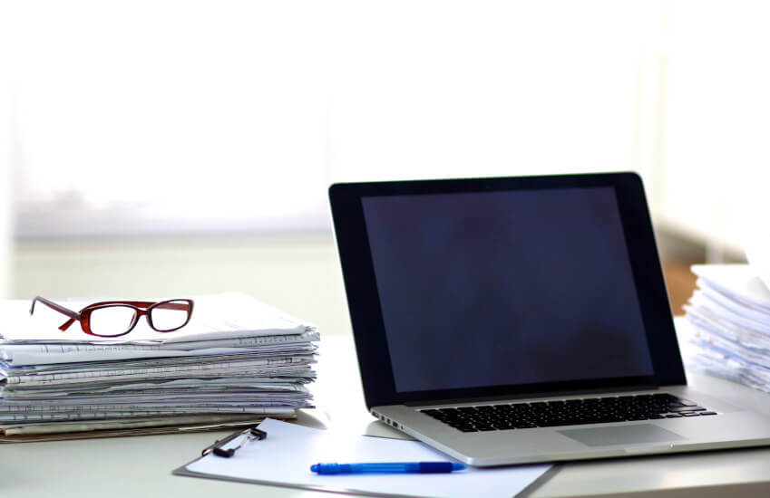 Workstation with papers and laptop